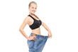 A happy weight loss female holding her old jeans A happy weight loss female holding her old jeans