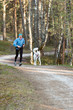 The sports woman with a dog run  in park