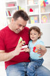 Toddler boy playing with his father