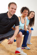 Three young people doing exercises