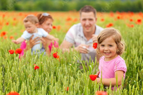 Photo: Young family in poppy field Young family in poppy field