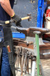 Farrier making a horseshoe