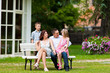 Family sitting in front of their home Family sitting in front of their home