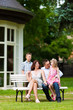 Family sitting in front of their home Family sitting in front of their home
