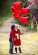 valentines kids with gift of balloons and kiss