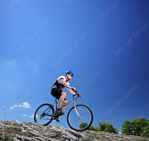 Photo: A man riding a mountain bike on a slope A man riding a mountain bike on a slope