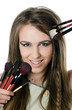 The beautiful girl with brushes for a make-up