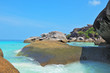 The  huge black cliffs and azure water