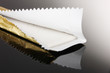 Chewing gum on the wrapping foil on gray background