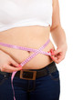 overweight, fat  woman measuring her belly