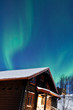 Northern lights above a cabin
