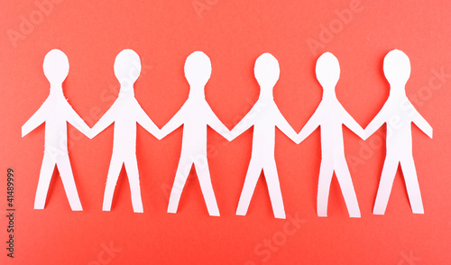 Photo: Paper people on red background Paper people on red background