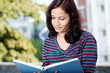 Young female student studying outdoors
