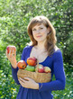 woman with apple harvest in garden woman with apple harvest in garden