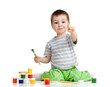 kid drawing with paints pointing to camera directly