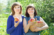 Happy women with apples in orchard Happy women with apples in orchard