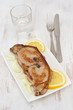 fried tuna with lemon and onion on the plate