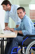Man in wheelchair at desk Man in wheelchair at desk