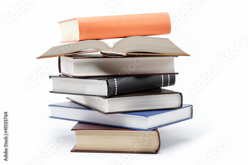 Photo: A stack of books on a white background. A stack of books on a white background.