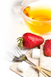 Cup of tea and strawberries over white Cup of tea and strawberries over white