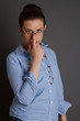 a caucasian brunette young woman wearing specs
