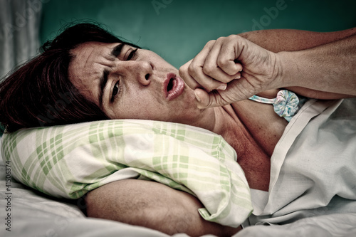 Photo: Grunge portrait of sick sickwoman coughing Grunge portrait of sick sickwoman coughing