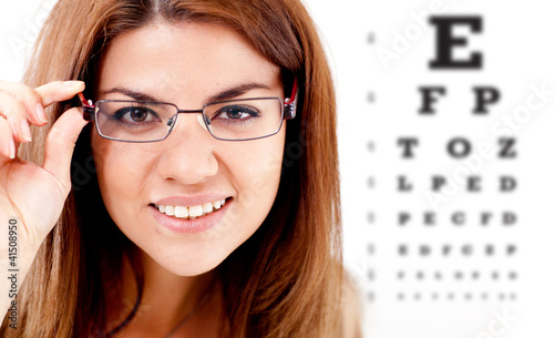 Photo: Woman taking an eye vision test Woman taking an eye vision test