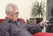 Foto: old man with television remote control old man with television remote control