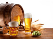 Beer barrel with beer glasses on a wooden table.