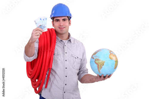 Photo: Plumber with a globe and handful of money Plumber with a globe and handful of money