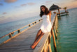 Sexy beautiful young summer girl sitting on a jetty (Maldives)