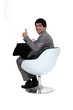 Smiling businessman giving the thumb's up