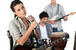 singer with guitar and microphone and male musicians