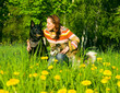 woman with her dog on meadow.