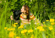 woman with her dog on meadow.