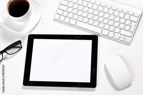 Photo: tablet is in the office of a businessman tablet is in the office of a businessman
