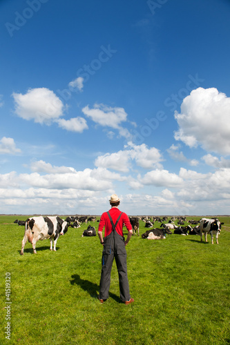 Photo: Typical Dutch landscape with farmer and cows Typical Dutch landscape with farmer and cows