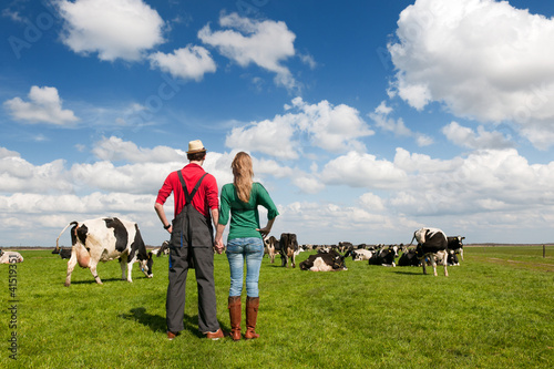 Photo: Typical Dutch landscape with farmer couple and cows Typical Dutch landscape with farmer couple and cows