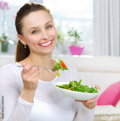 Photo: Diet. Healthy Young Woman Eating Vegetable Salad Diet. Healthy Young Woman Eating Vegetable Salad