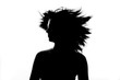 Silhouette of beautiful girl spinning her head with flying hair Silhouette of beautiful girl spinning her head with flying hair