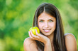 woman with bare shoulders holding an apple