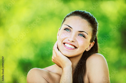 Photo: woman with bare shoulders laughs and looks up woman with bare shoulders laughs and looks up