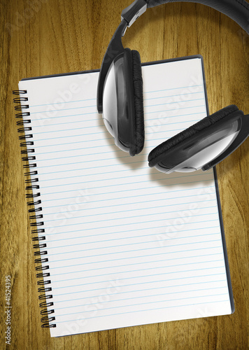 Photo: notepad and headphones notepad and headphones