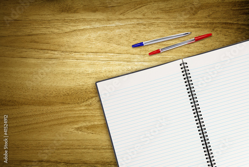 Photo: open work book and pens open work book and pens