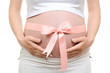 Foto: Pregnant belly with pink ribbon Pregnant belly with pink ribbon