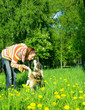 woman with her dog on meadow