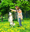 woman with her dog on meadow