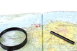 Magnifying Glass and pencil on the map Magnifying Glass and pencil on the map