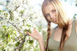 beautiful woman standing near the apple tree