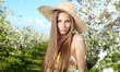 beautiful woman standing near the apple tree